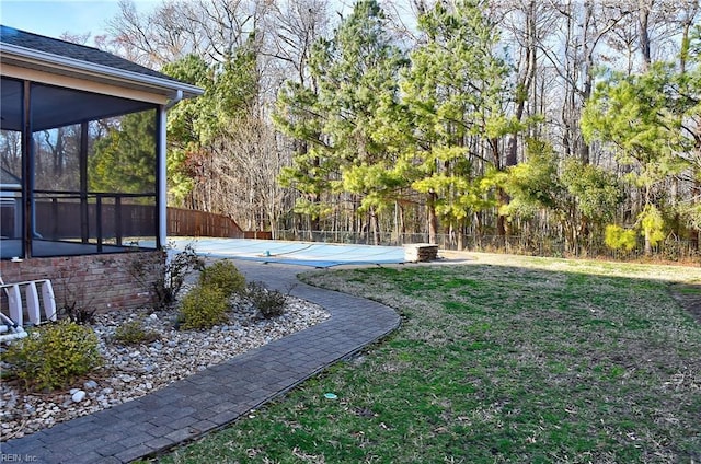 view of yard featuring a sunroom and fence