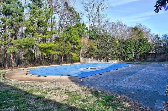 view of swimming pool featuring a patio area, fence, and a fenced in pool