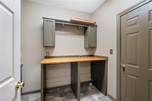 washroom with baseboards