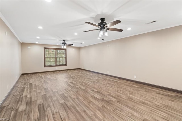 spare room featuring baseboards, visible vents, ornamental molding, light wood-type flooring, and recessed lighting