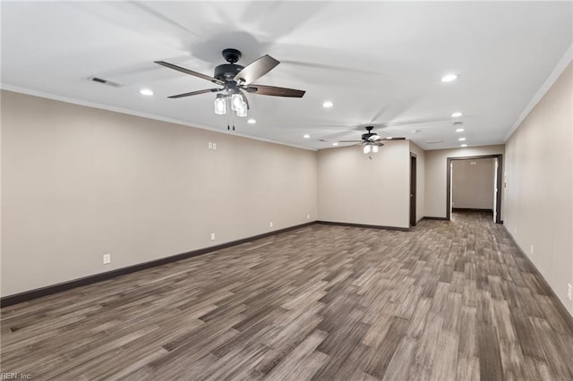 spare room featuring visible vents, baseboards, wood finished floors, crown molding, and recessed lighting