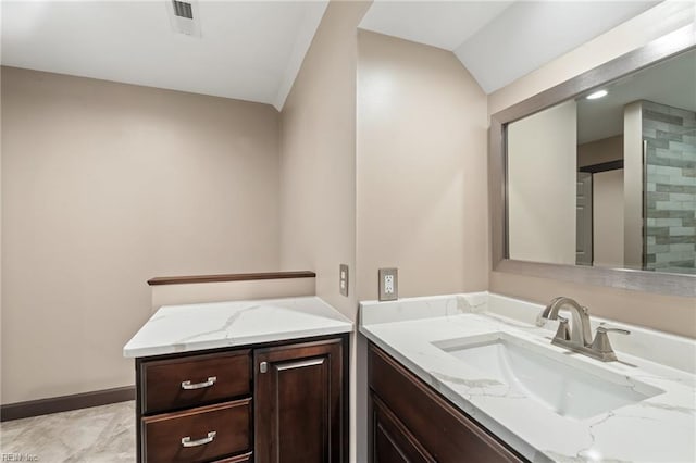 bathroom with visible vents, vanity, and baseboards