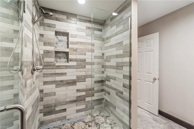 full bath featuring a stall shower and baseboards