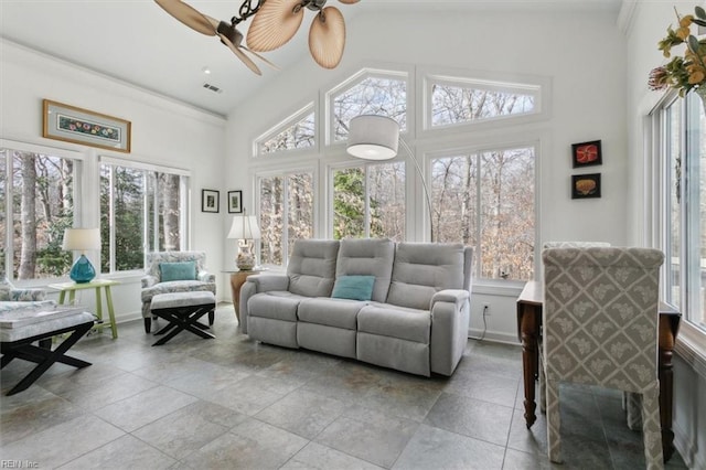 sunroom featuring lofted ceiling, plenty of natural light, and visible vents