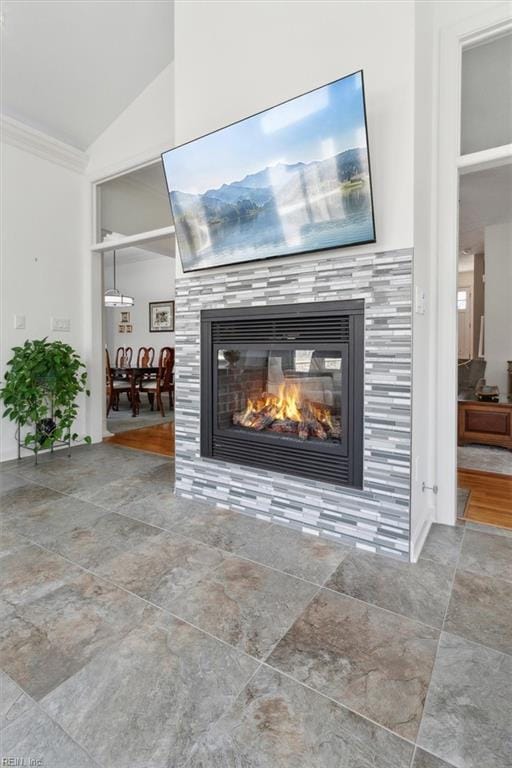 room details with ornamental molding and a tiled fireplace