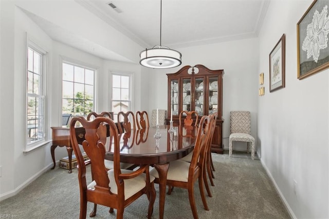 dining space featuring baseboards, visible vents, carpet flooring, and ornamental molding