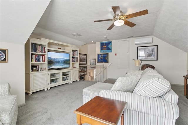 living area with a textured ceiling, carpet floors, a wall mounted AC, and lofted ceiling