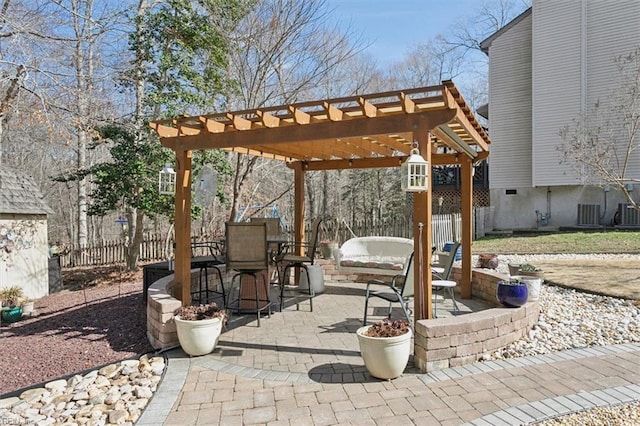 view of patio featuring fence, a pergola, and outdoor dining space