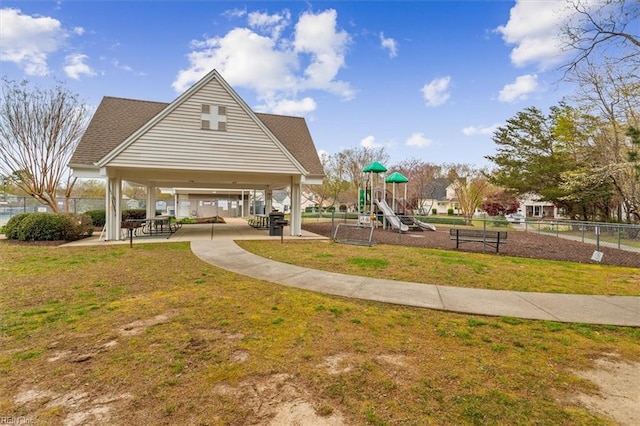 community play area featuring fence, a lawn, and a gazebo