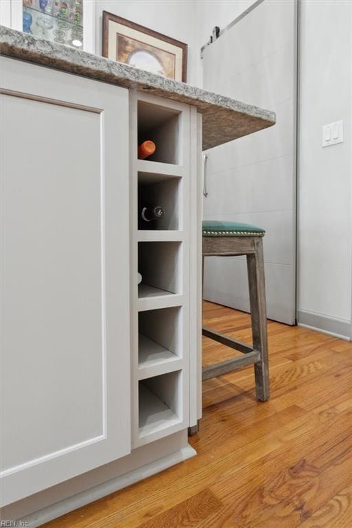 room details featuring a barn door and wood finished floors