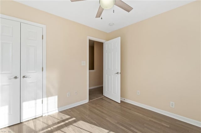 unfurnished bedroom featuring a ceiling fan, baseboards, and wood finished floors