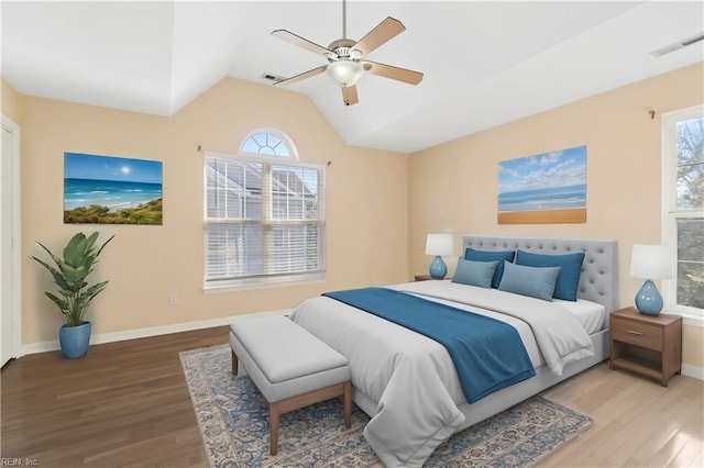 bedroom featuring multiple windows, visible vents, and wood finished floors