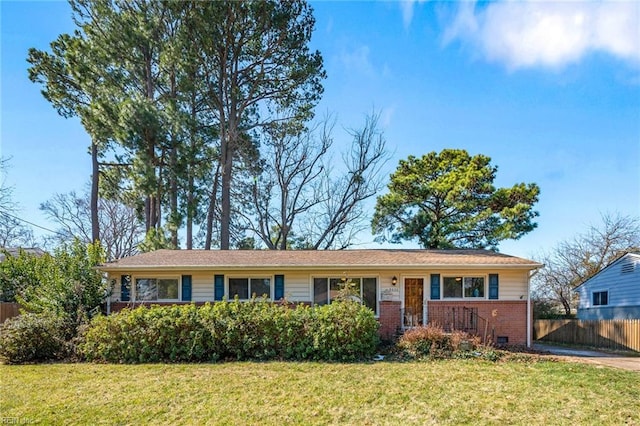 ranch-style house featuring crawl space, brick siding, fence, and a front yard