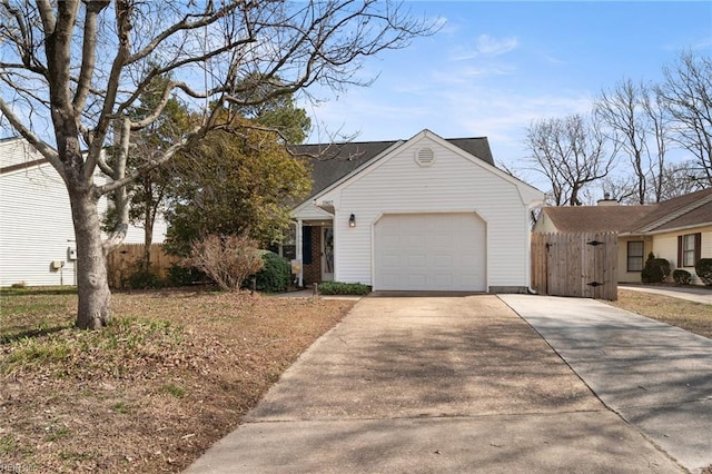 view of front facade featuring an attached garage, fence, and concrete driveway