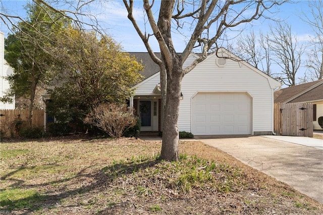 view of front facade featuring a garage, driveway, and fence