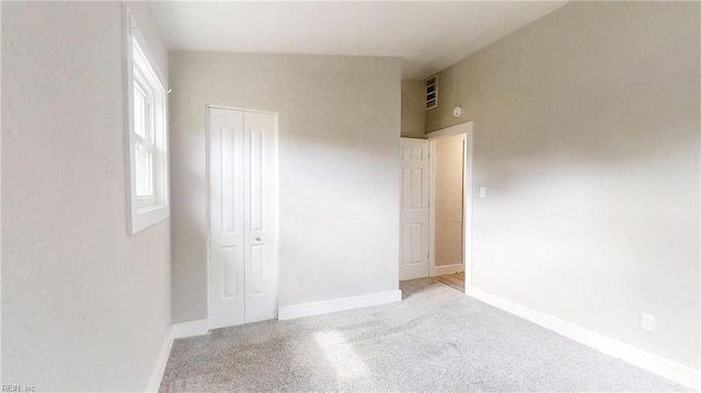 interior space with carpet, baseboards, and a closet