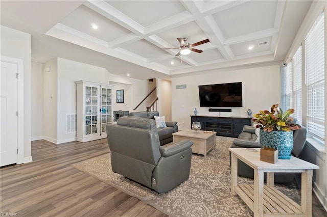 living room with coffered ceiling, wood finished floors, visible vents, stairway, and beamed ceiling