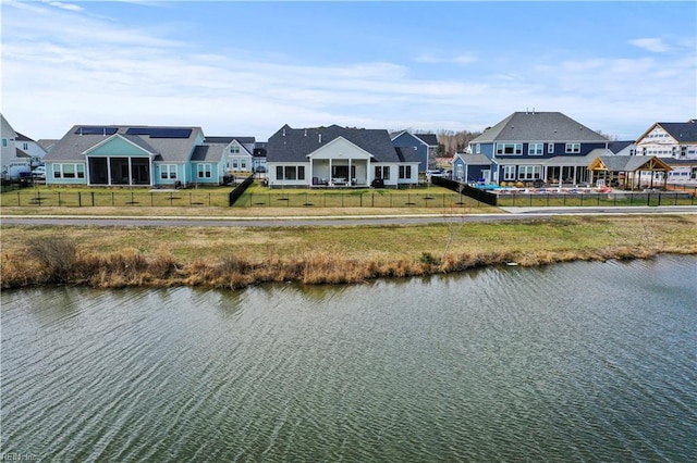 water view with a residential view and fence