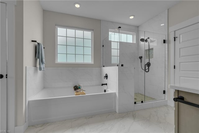 bathroom with marble finish floor, recessed lighting, a garden tub, and a shower stall