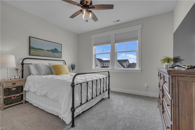 bedroom with baseboards, a ceiling fan, visible vents, and light colored carpet