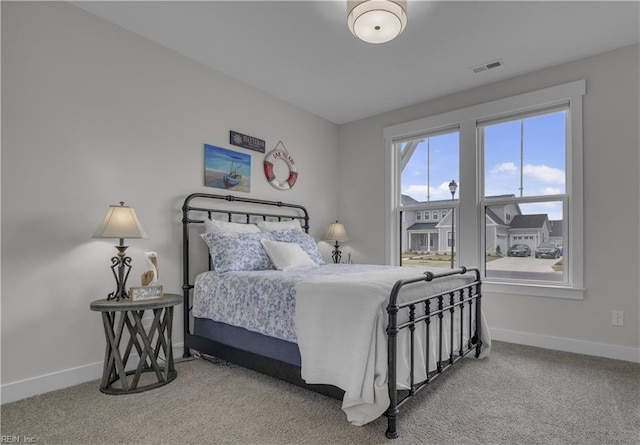 bedroom with baseboards, visible vents, and carpet flooring