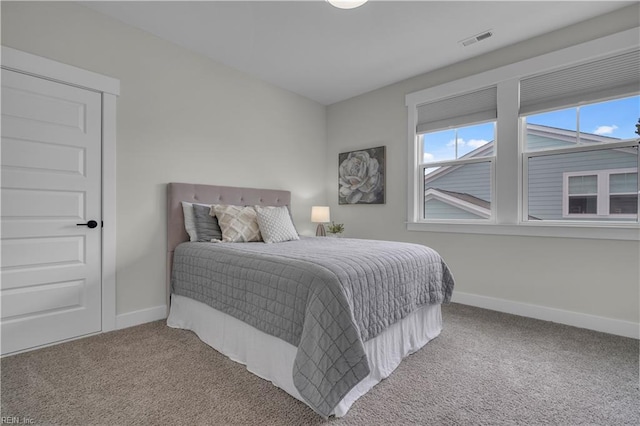 carpeted bedroom with baseboards and visible vents