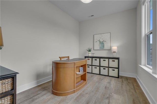 home office featuring light wood-type flooring and baseboards