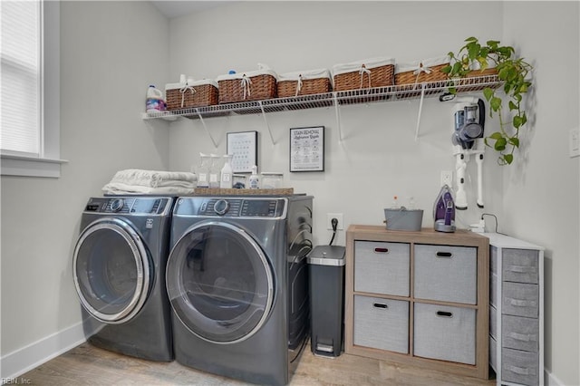 laundry area with light wood-style floors, laundry area, independent washer and dryer, and baseboards