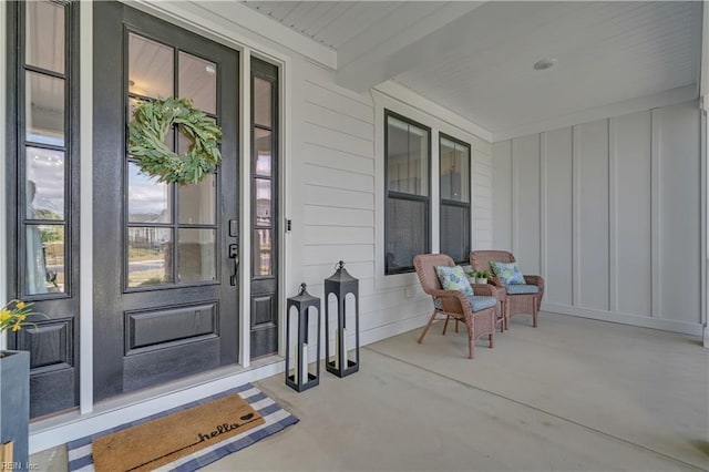 entrance to property with a porch and board and batten siding