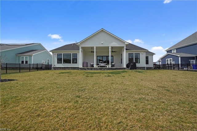 rear view of house featuring a patio, a lawn, a fenced backyard, and a ceiling fan