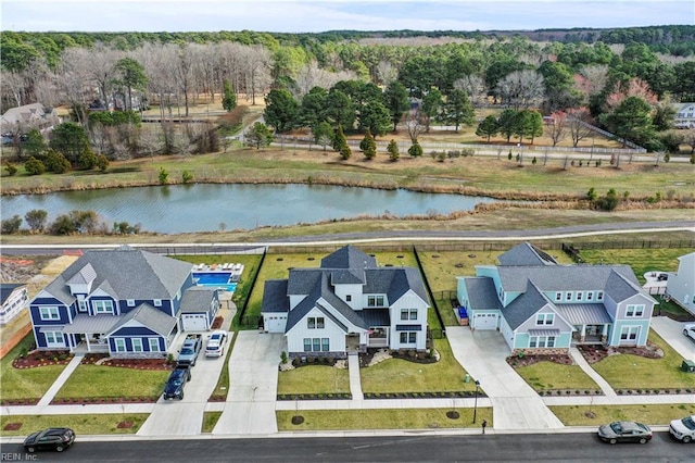 drone / aerial view featuring a residential view and a water view