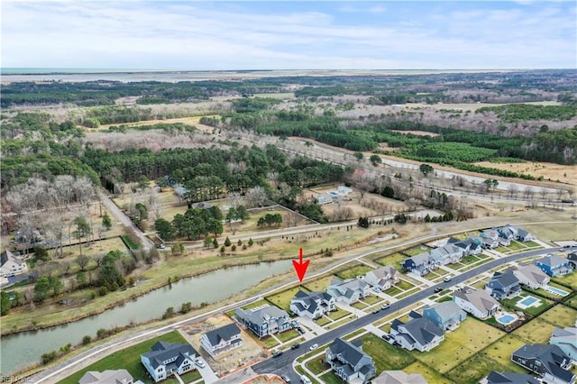 birds eye view of property featuring a water view and a residential view