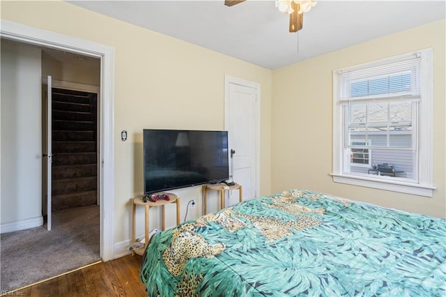 bedroom with dark wood finished floors, baseboards, and ceiling fan