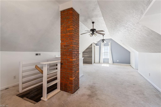 additional living space featuring lofted ceiling, baseboards, carpet floors, and a textured ceiling