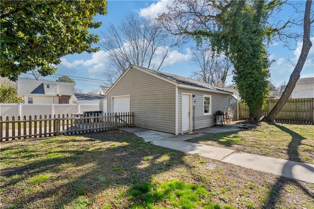 view of outdoor structure featuring fence private yard and an outdoor structure