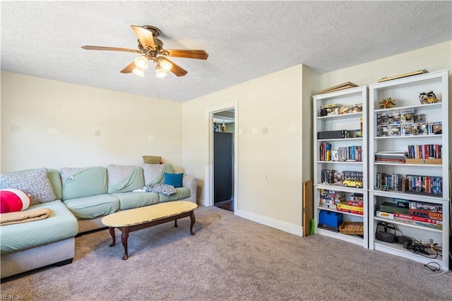 living area featuring carpet floors, a textured ceiling, and a ceiling fan