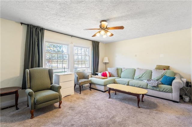 living area with a textured ceiling, a ceiling fan, and light colored carpet