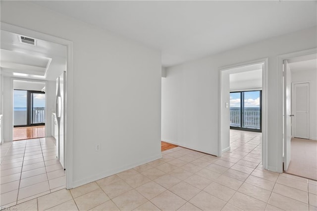 unfurnished room with visible vents, baseboards, and light tile patterned floors