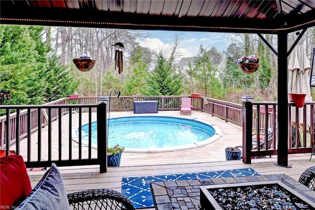 view of swimming pool featuring a deck and a gazebo