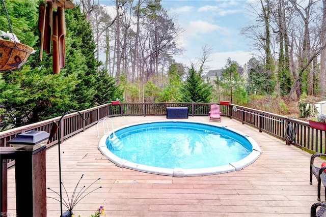 outdoor pool with a wooden deck