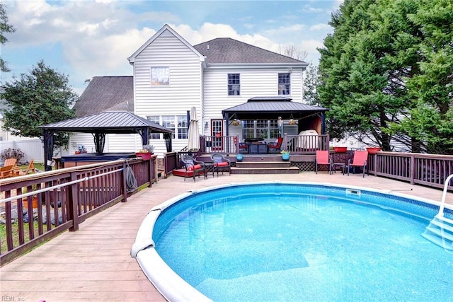 pool with a wooden deck and a gazebo