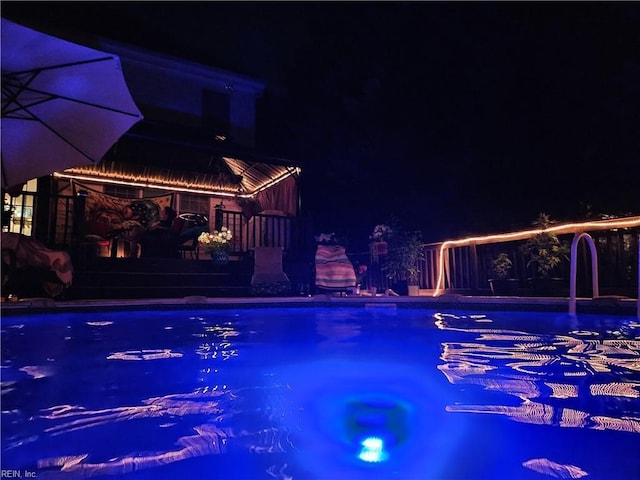 pool at twilight featuring an outdoor pool