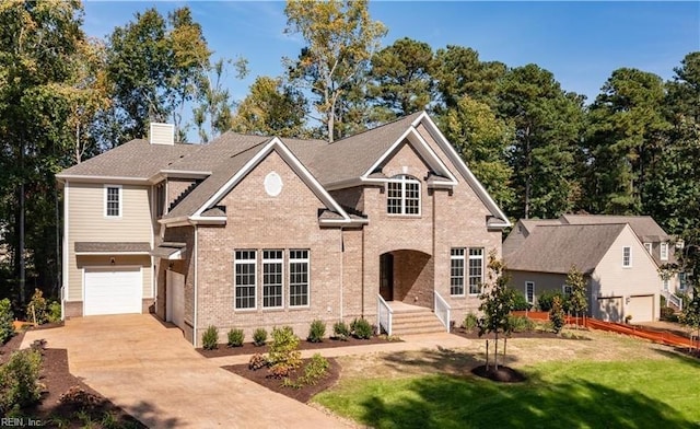 view of front of property with brick siding, a front yard, a chimney, a garage, and driveway