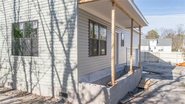 view of property exterior with crawl space and fence