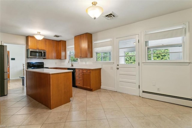 kitchen with black appliances, light countertops, visible vents, and brown cabinets