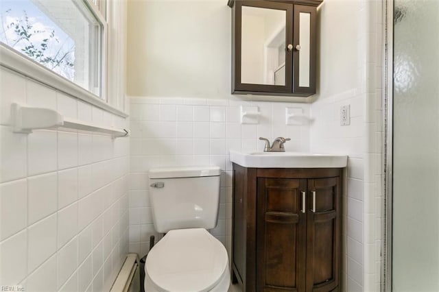 bathroom featuring wainscoting, toilet, an enclosed shower, vanity, and tile walls