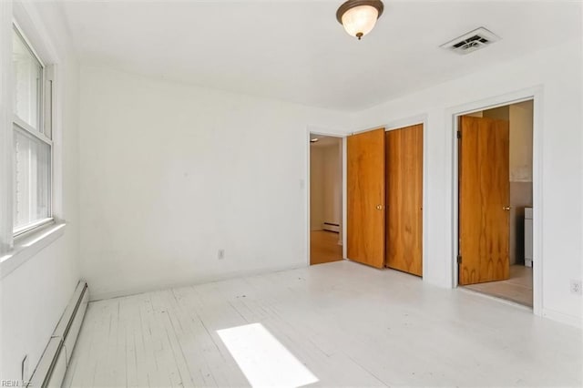 interior space featuring a baseboard radiator and visible vents