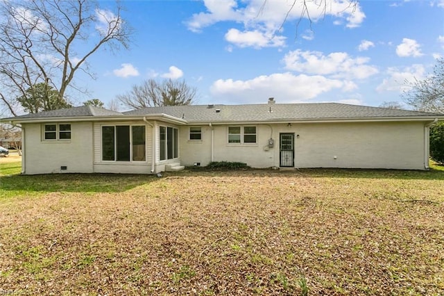 rear view of house with a yard