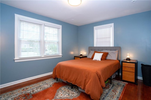 bedroom featuring baseboards and wood finished floors