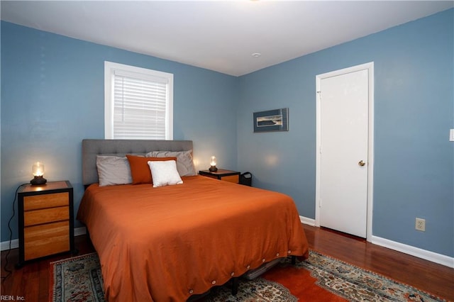 bedroom with wood finished floors and baseboards